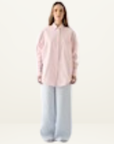 Esmaee Bayview oversized button-down shirt in pink and white vertical stripes paired with light blue wide-leg trousers.