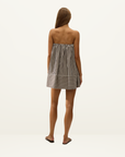 Back view of a strapless cotton mini dress in Rita stripe port featuring a relaxed tent silhouette and wide hem panel.