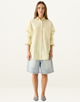 Esmaee Bayview button-down shirt in lemon yellow with vertical stripes, featuring a chest pocket and relaxed fit.