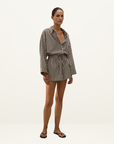 Faithfull Belas cotton playsuit in Rita stripe port featuring a collared shirt top, drawstring waist, and relaxed shorts.