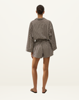 Back view of Faithfull Belas cotton playsuit in Rita stripe port featuring an oversized shirt silhouette and elastic waist.