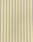 Close-up of the Esmaee Bayview shirt featuring a vertical lemon yellow and blue pinstripe pattern on smooth fabric.
