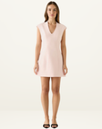 Model wearing a ballet pink Esmaee mini dress with a V-neckline, cap sleeves, and a structured, tailored silhouette.