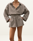 Faithfull Belas cotton playsuit in Rita stripe port featuring an oversized collared shirt, drawstring waist, and pockets.