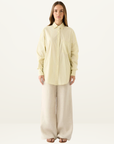 Esmaee Bayview oversized button-down shirt in lemon yellow with vertical stripes and a front chest pocket.