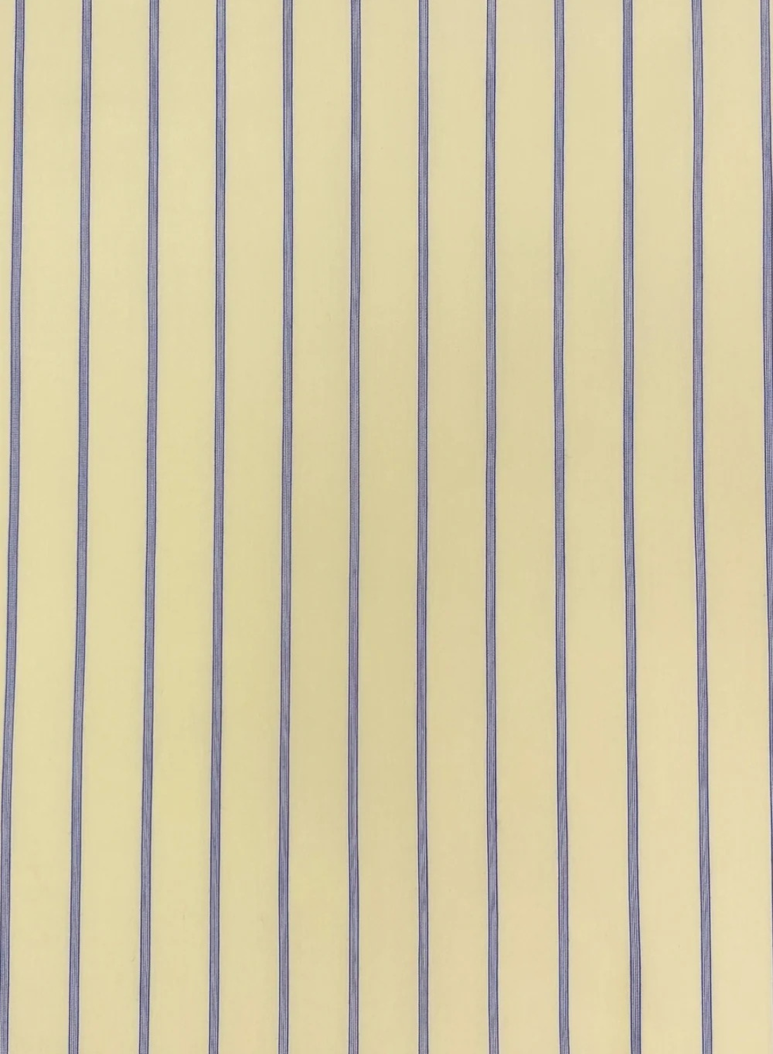 Close-up of the Esmaee Bayview shirt featuring a vertical lemon yellow and blue pinstripe pattern on smooth fabric.