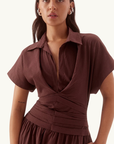 Sovere Lyra midi dress in chocolate stretch cotton featuring a collared neckline, magyar sleeves, and a pleated waistband.