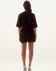 Back view of a black cotton Sovere Sovhi tee dress with a relaxed fit, elbow-length sleeves, and a mini length.